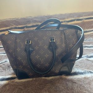 Louis Vuitton magnetic closure tote purse with black accents and shoulder strap
